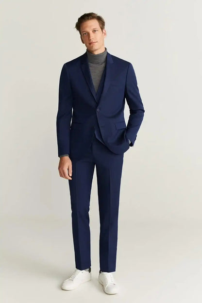Blue suit with single-breasted jacket and straight-leg trousers, gray turtleneck