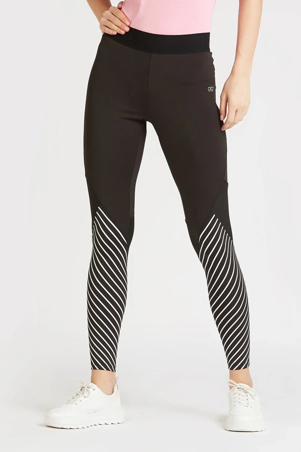 Black performance leggings with vertical striped panels at calves