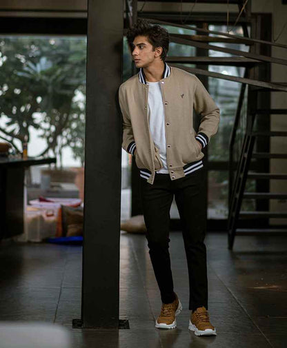 Men's tan fitted bomber jacket with striped ribbed cuffs and stand collar, front view