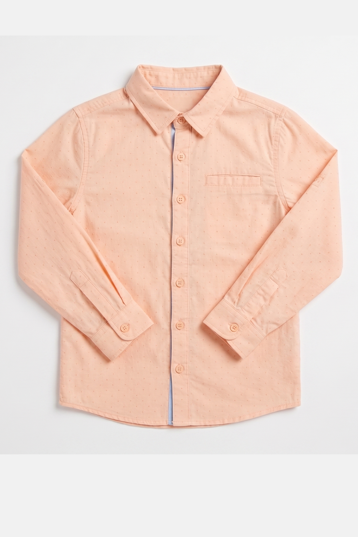 Peach button-up shirt close-up, long sleeves, buttoned placket and chest pocket