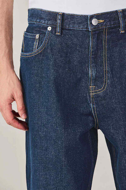 Dark blue denim jeans with curved pocket design and contrast stitching