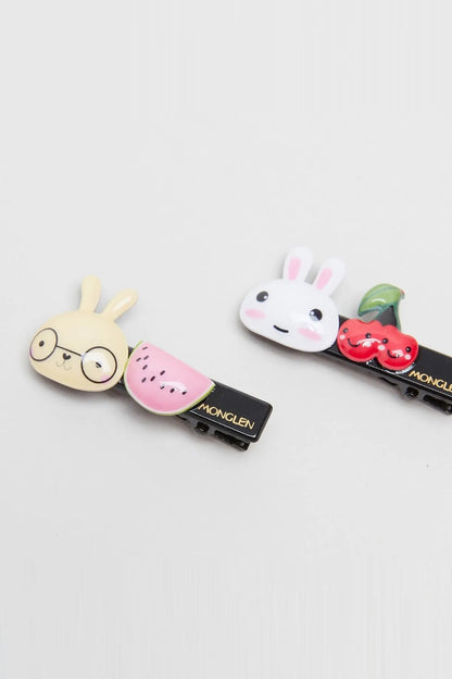 Cartoon animal hair clips set showing snail and bunny faces on black clips
