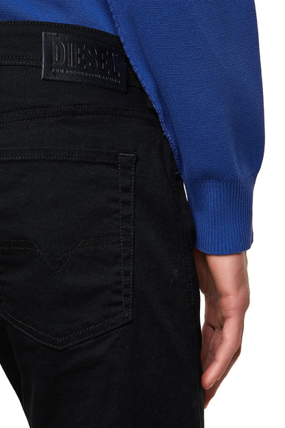 Black jeans with Diesel logo patch on waistband and back pocket