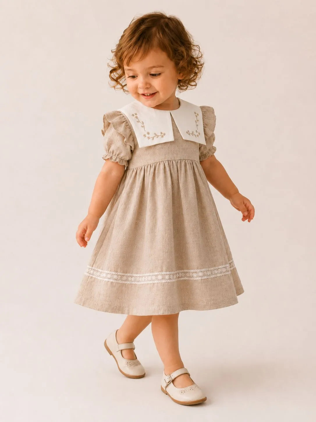 Girls stone linen dress with puff sleeves, white collar, and decorative hem trim