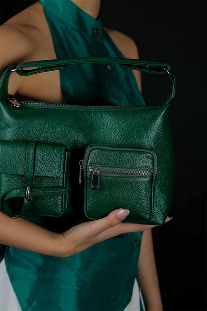 Emerald green leather-look handbag close-up, front flap and zip pocket, strap