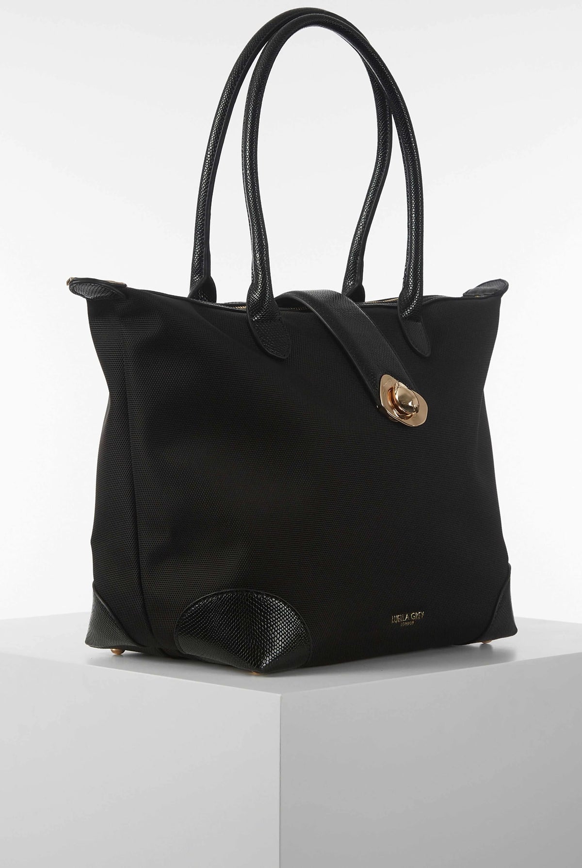 Black structured tote bag with gold clasp and textured front pocket