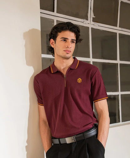 Maroon fitted polo shirt with yellow-trim sleeves and chest crest, front three-quarter view