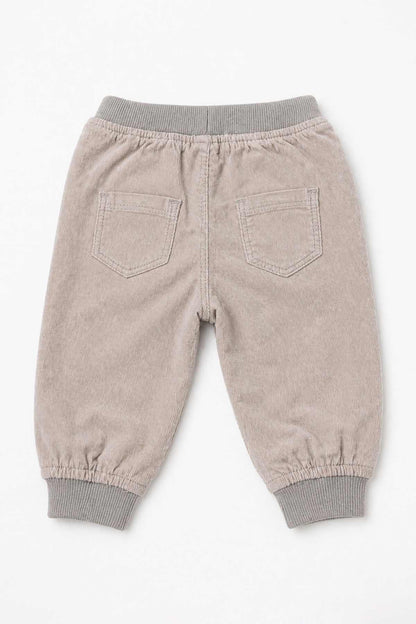 Beige baby trousers with elastic ankle cuffs and back pocket design