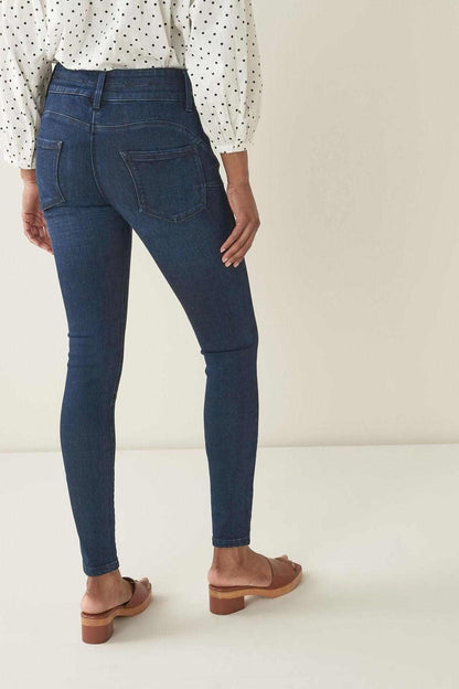 Inky denim skinny jeans with rear patch pockets, belt loops, and button front