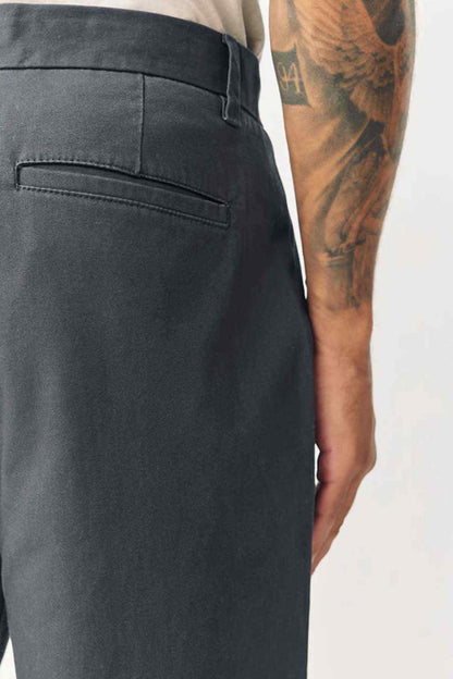 Dark grey trouser waistband with belt loops and front pocket seam