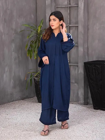 Navy blue long kurta with V-neck and sleeves, model holding collar near ear