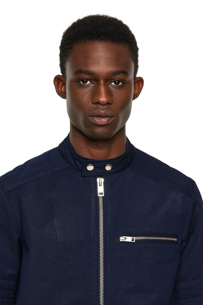 Dark blue jacket front with stand collar snaps and zip pocket detail
