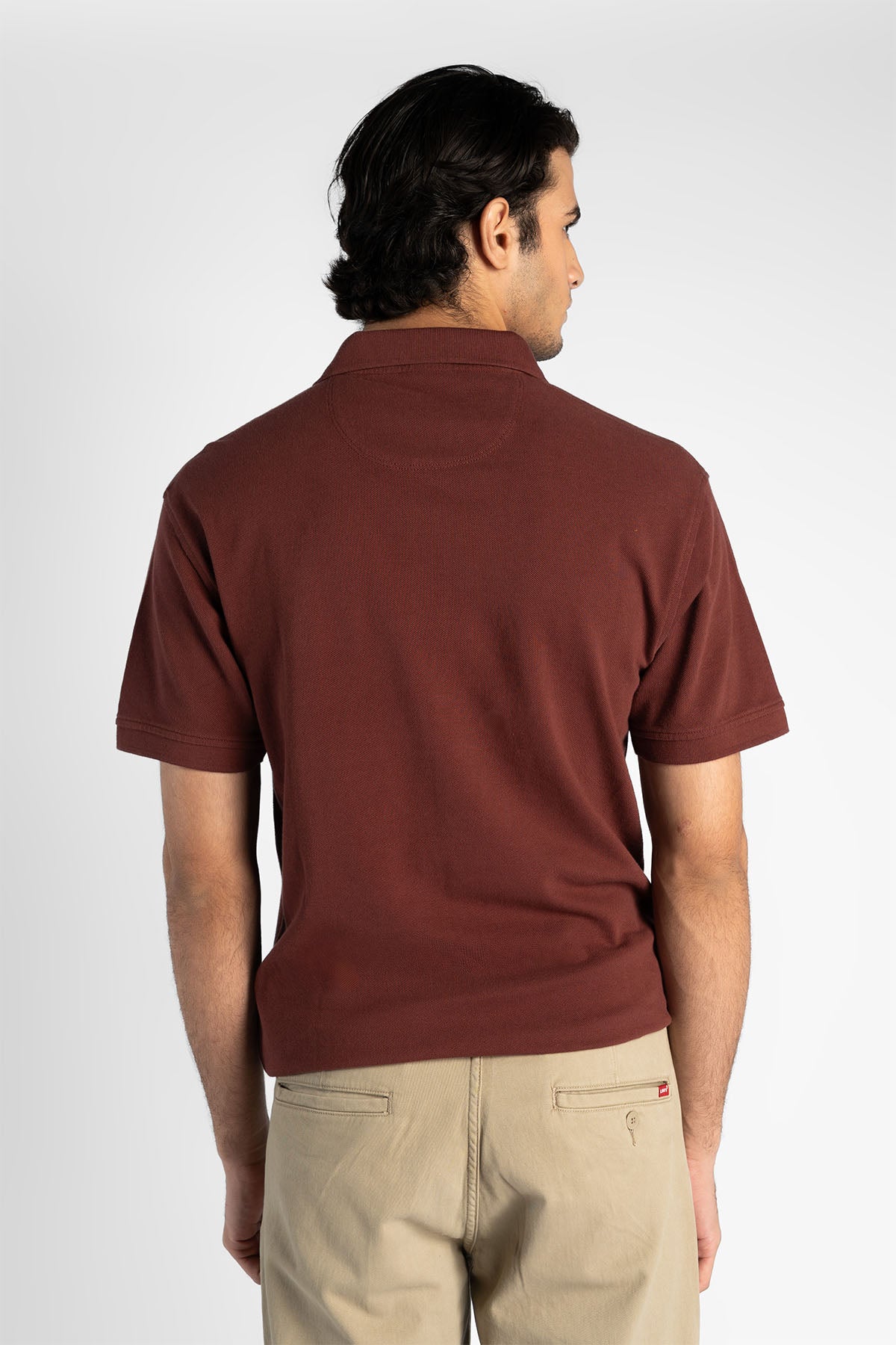 Maroon polo shirt back view with short sleeves and buttoned collar