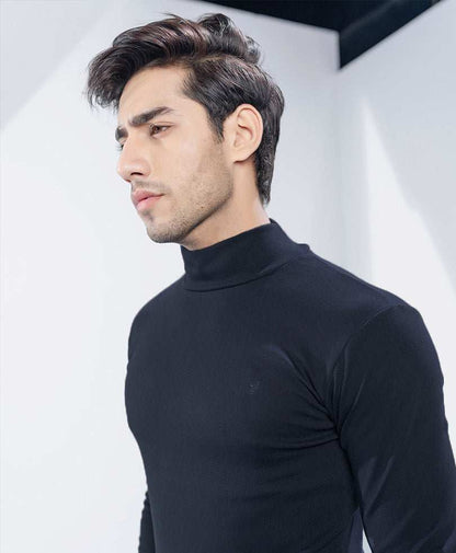 Fitted black long-sleeve turtleneck top close-up of high mock neck and shoulders