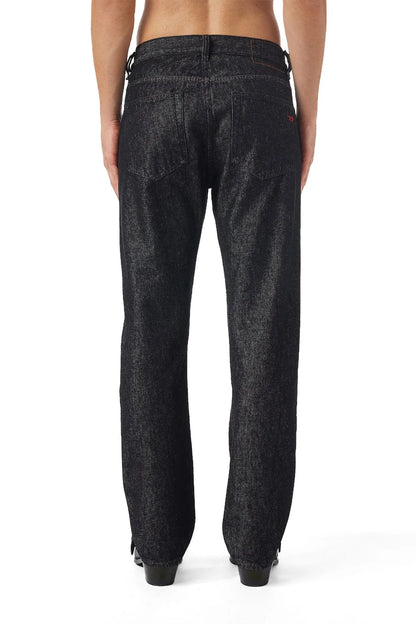 Diesel black denim jeans on model, back view with yoke seam and belt loops