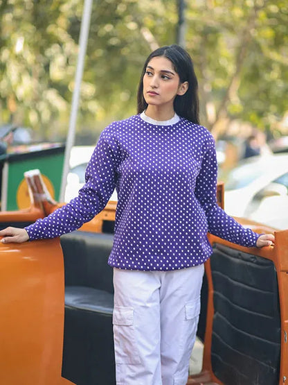 Purple polka-dot long-sleeve top with white crew neck and curved hem