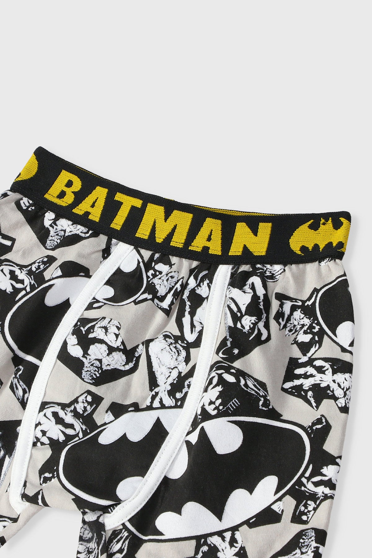 Batman boxer shorts close-up: yellow “BATMAN” waistband, white drawstring