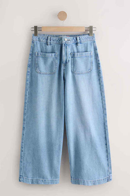 Light blue wide-leg denim pants on hanger with button front and patch pockets.