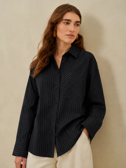 Black pinstriped button-up shirt with breast pocket, long sleeves, collared neck