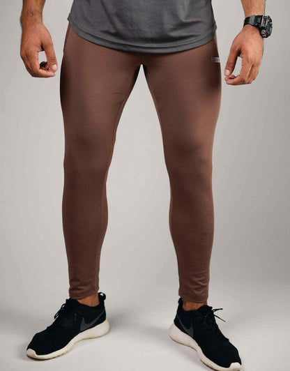Brown compression leggings with flat front seam and tapered ankle fit
