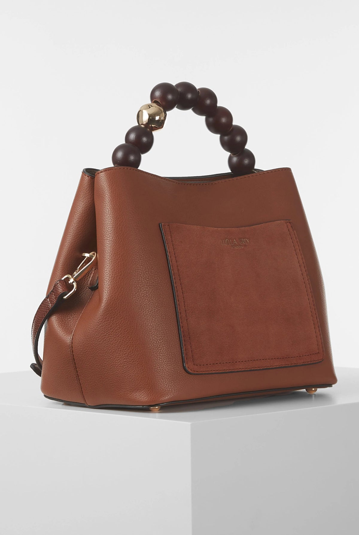 Brown leather handbag with beaded top handle and front square patch pocket.