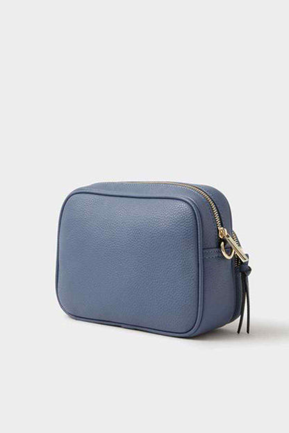 Blue rectangular crossbody bag with gold zipper and strap attachment detail