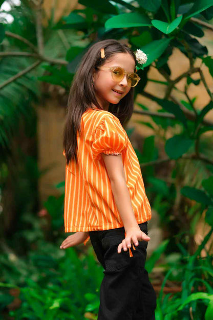 Kids orange striped short-sleeve shirt and black pants, side profile