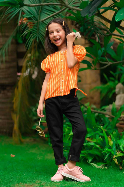 Kids orange striped button-up shirt with black pants and sneakers, full-body