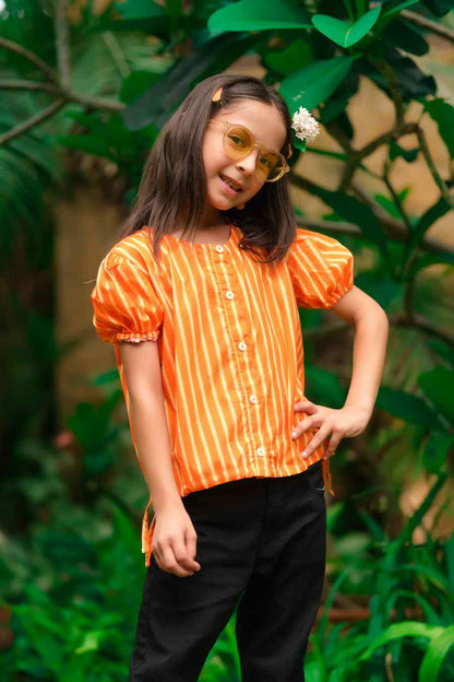 Kids orange striped short-sleeve button-up shirt with black pants, side view
