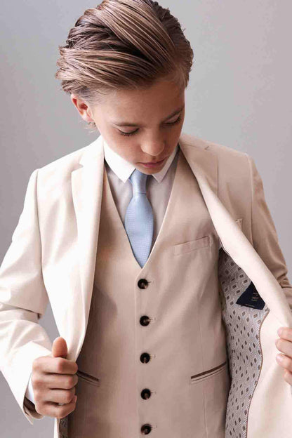 Cream blazer with notch lapels and chest pocket, worn over light blue vest