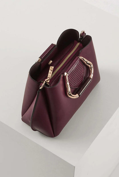 Berry handbag with open top showing gold zipper and interior