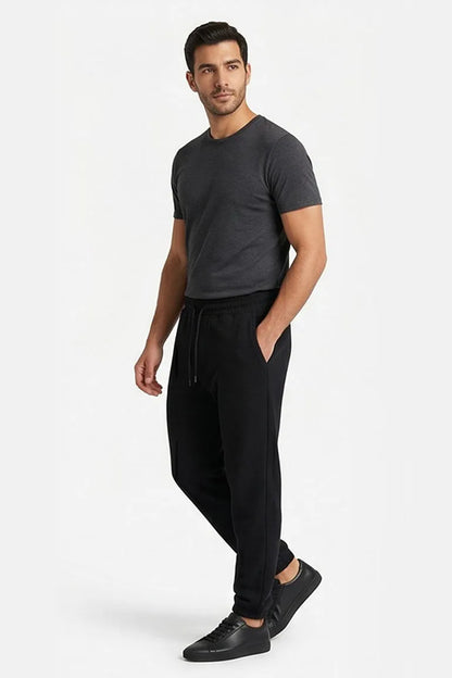 Black jogger pants with drawstring waist, side pockets, and tapered legs