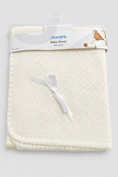 Folded baby shawl in white knit with decorative edge, shown on hanger packaging