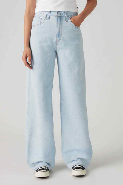 Light indigo wide-leg jeans, button fly and front pockets.