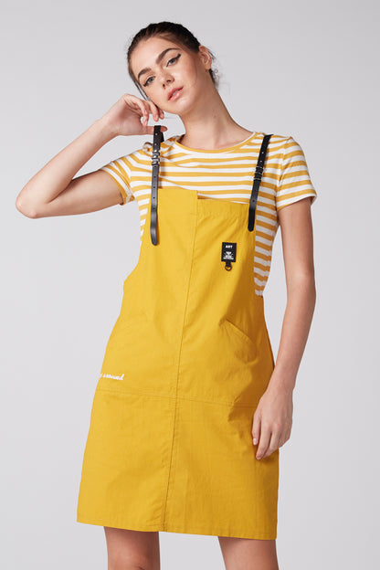 Yellow bib overalls with black straps over striped short-sleeve T-shirt