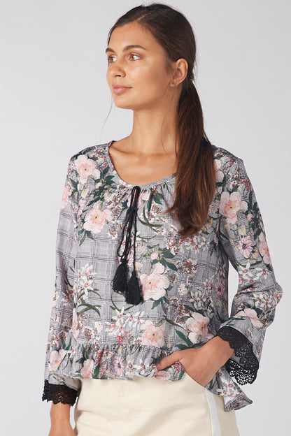 Grey floral blouse with ruffle neckline and lace-trim cuffs