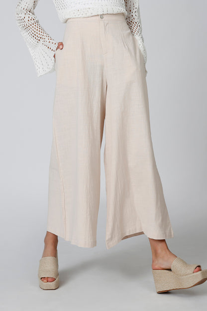 Beige wide-leg pants with front crease and straight cropped hem