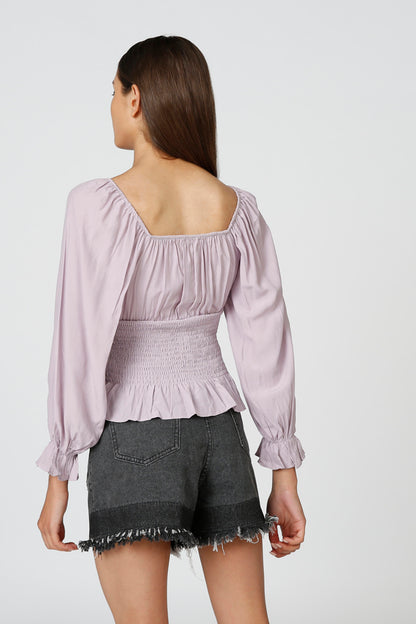 Lavender peplum blouse back view with smocked yoke and long puff sleeves