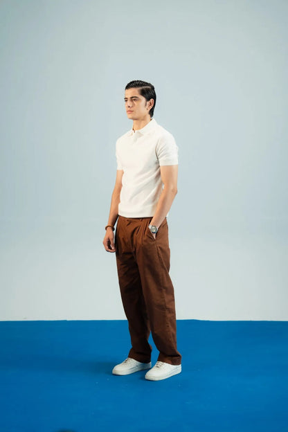 Brackets polo shirt and trousers: white short-sleeve polo with brown chino-style trousers