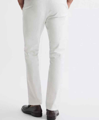 White fitted stretch chinos with tapered leg, button closure and cuffed hem