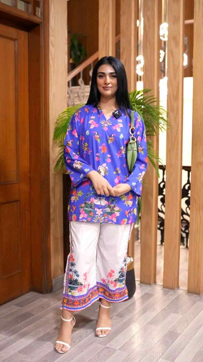 Blue floral printed long kurta with white pants, front view, round neckline