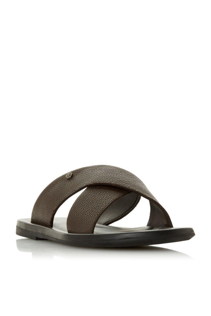 Brown slide sandals with curved cross strap over foot, open toe and flat sole