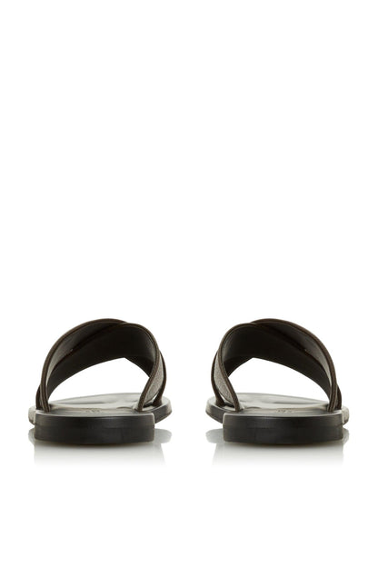 Pair of brown slide sandals with open toe and wide strap, flat dark sole