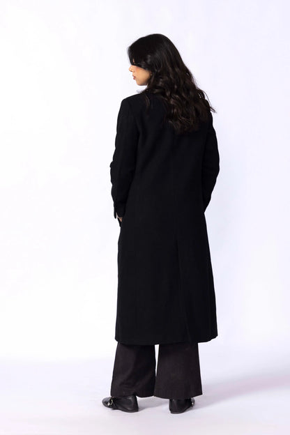 Black long coat shown from the back; full-length cut with long sleeves.