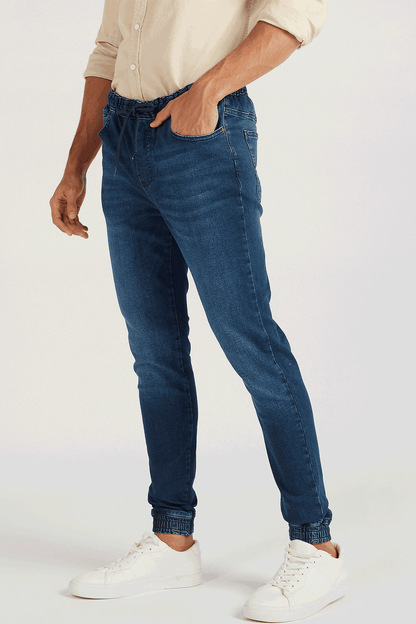 Blue denim jogger jeans with drawstring waist and cuffed ankles
