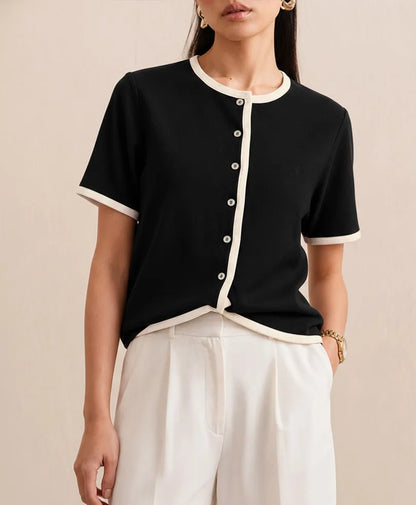 Black fitted short-sleeve top with front button placket and white contrast trim