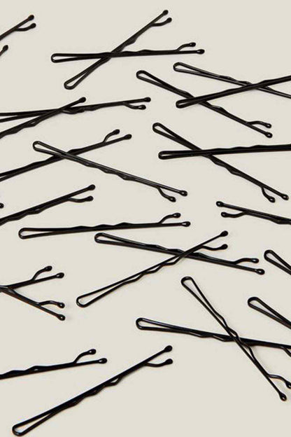 Black hair pins laid out, close-up view