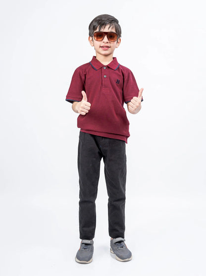 Maroon cotton polo shirt with short sleeves, collar, and button placket
