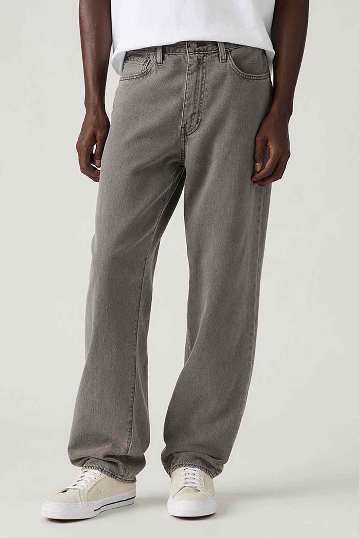 Grey denim jeans close-up, button fly, front pockets and straight legs