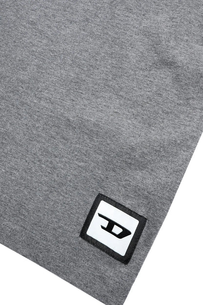 Grey T-shirt hem with black-and-white square DIESEL logo patch